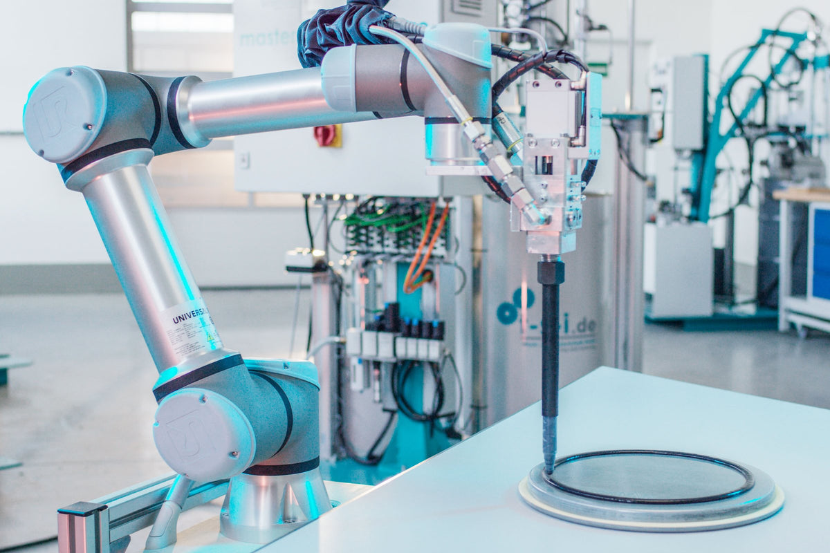 Robot with dispensing valve applying a bead to a component
